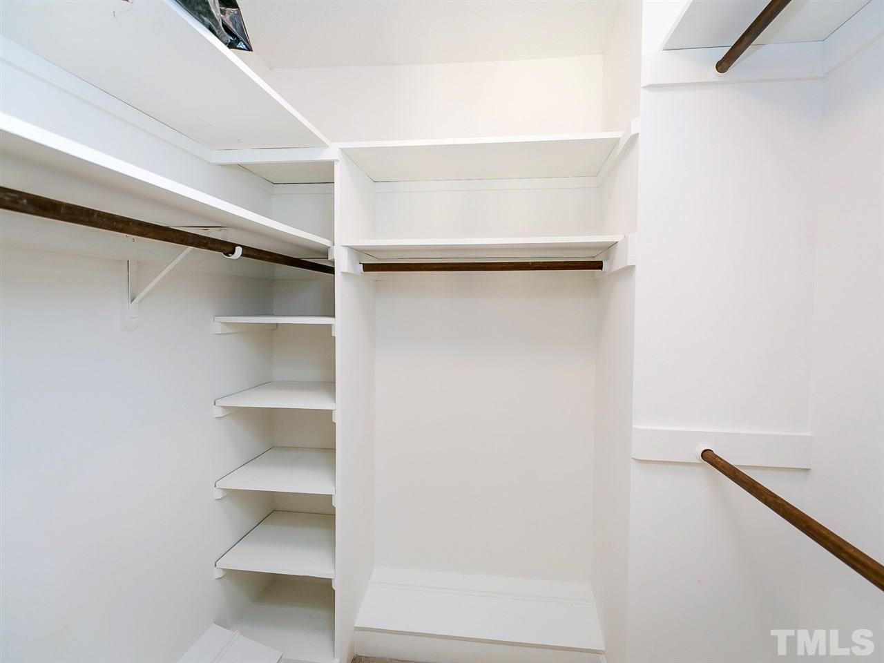 6116 Bayberry Lane Raleigh, NC 27612 - Photo 16 of 25 The second large closet in the Master Bedroom. Double tiered on the right side with shoe racks below and shelving above