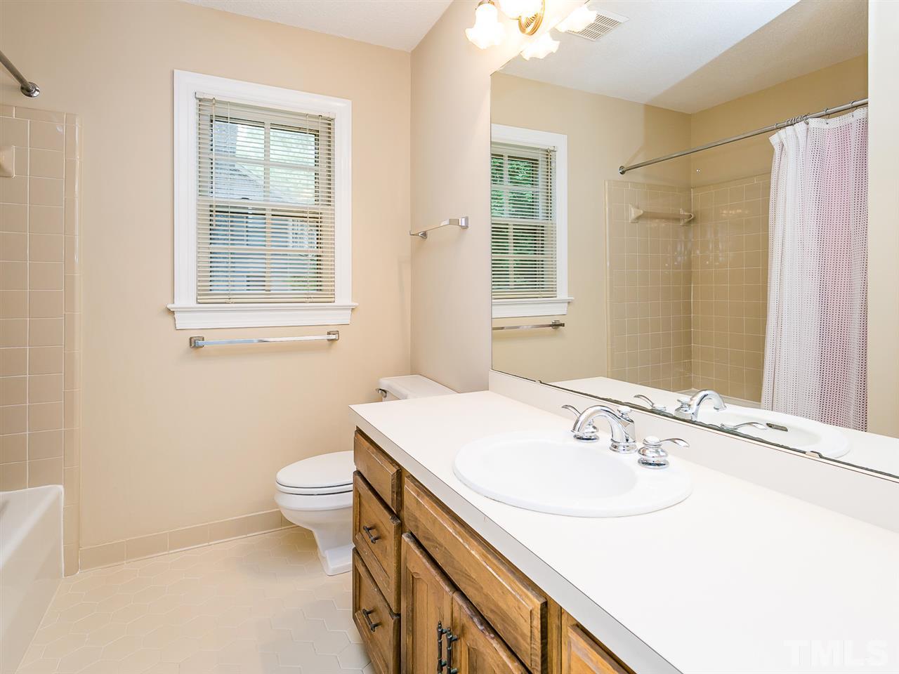 6116 Bayberry Lane Raleigh, NC 27612 - Photo 20 of 25 Tile floor and tile surround in bath