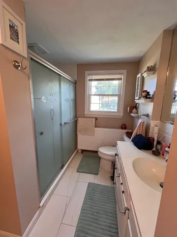 a kitchen with a sink a refrigerator and a large window