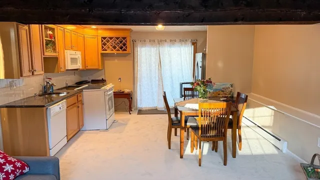 a dining room with furniture and a window