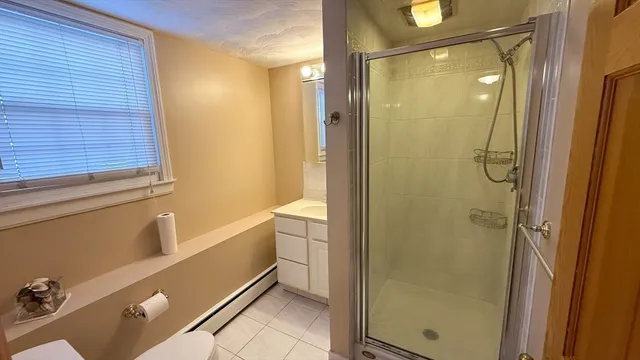 a bathroom with a shower and a sink