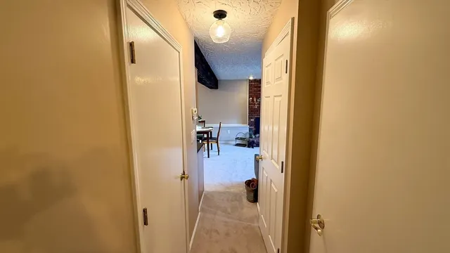 a view of a hallway with a dining room
