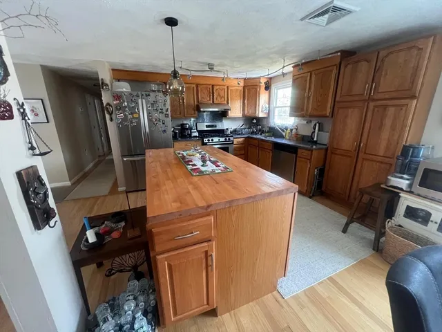 a kitchen with refrigerator and window