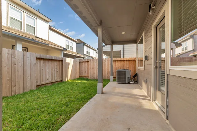 a view of a porch with couches and wooden fence