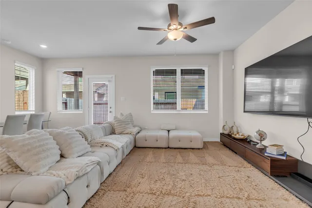 a living room with furniture and windows