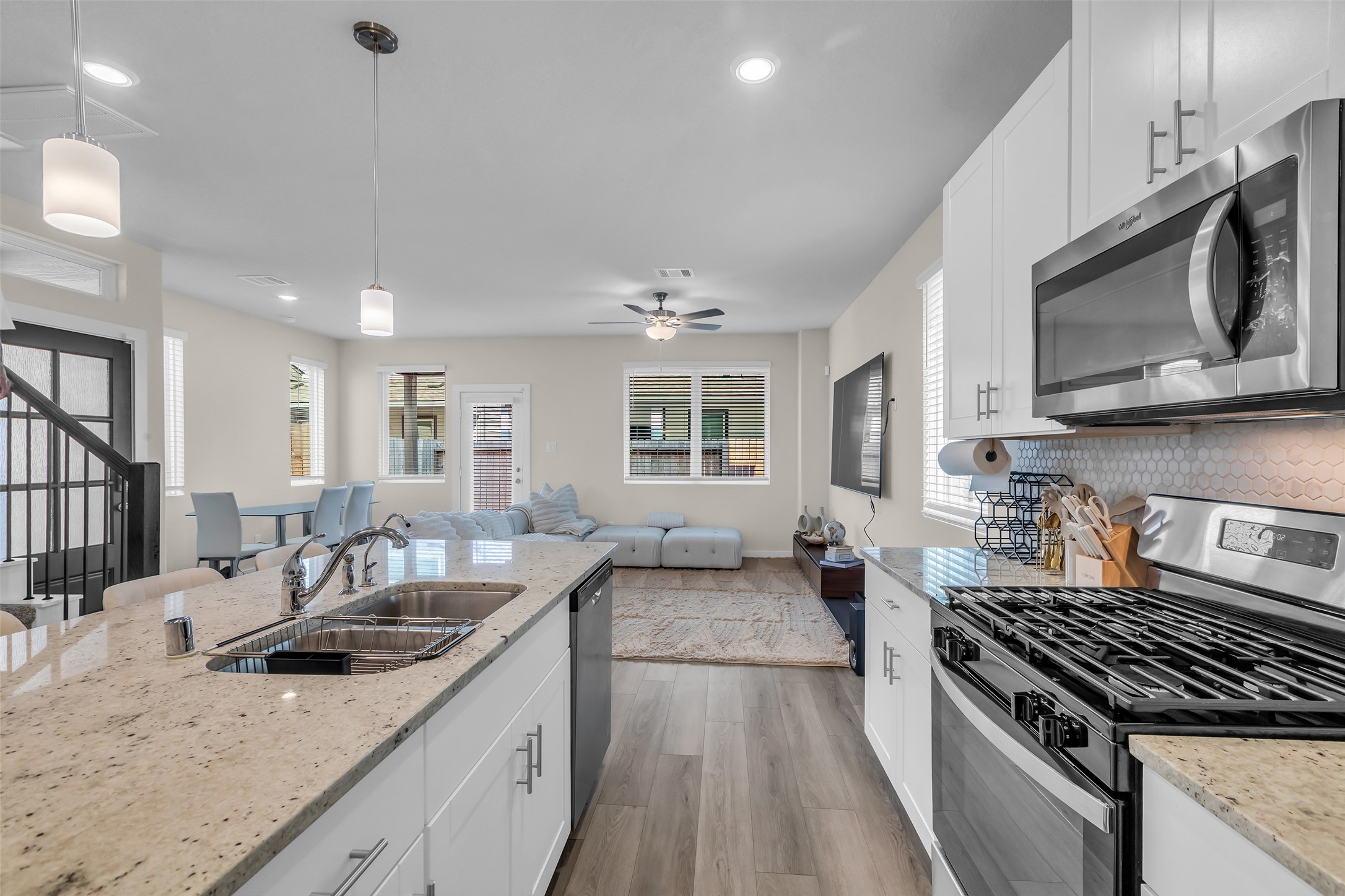 3109 Boulder Rnch Drive Houston, TX 77063 - Photo 9 of 26 a kitchen with stainless steel appliances granite countertop a sink stove and microwave