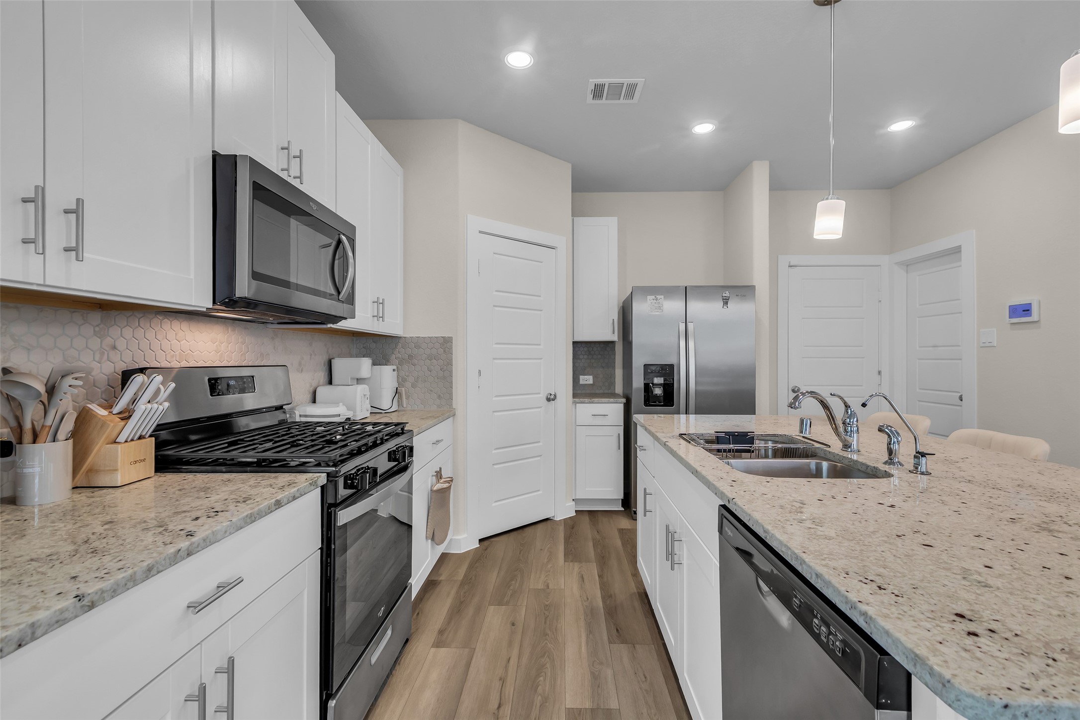 3109 Boulder Rnch Drive Houston, TX 77063 - Photo 10 of 26 a kitchen with stainless steel appliances granite countertop a sink stove and refrigerator