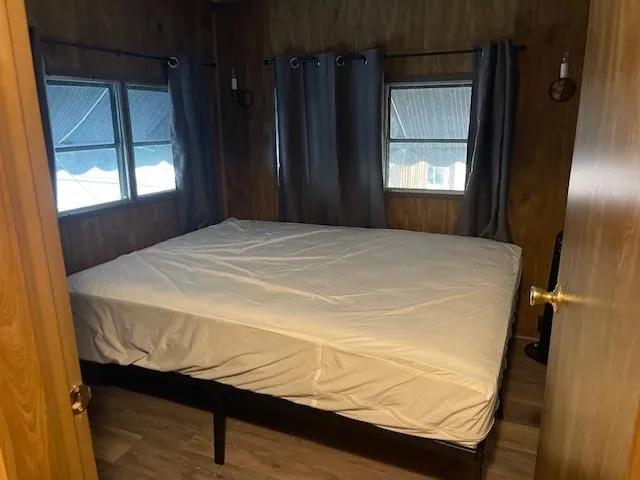 a bed sitting in a bedroom next to a window