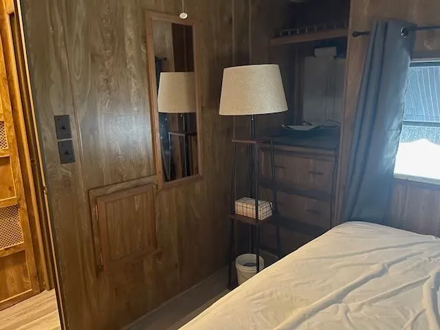 a bedroom with a bed and a lamp on table