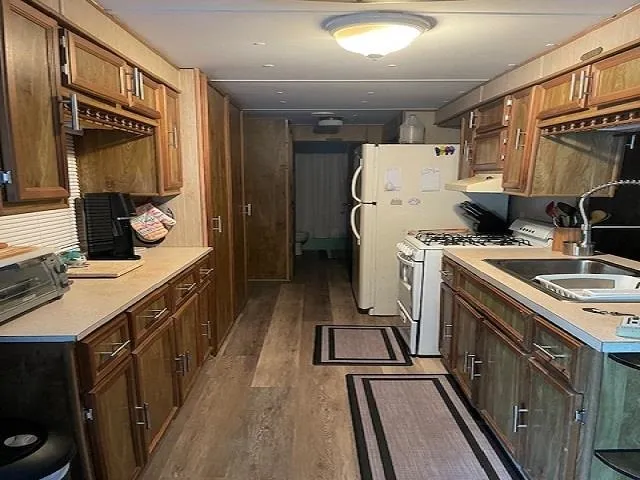 a kitchen with a sink appliances and cabinets