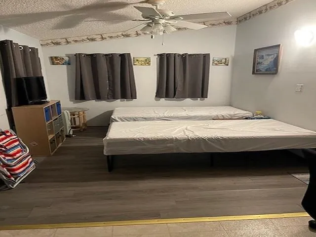 a bedroom with a bed a couch and dresser