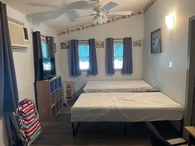 a bedroom with a bed table and window