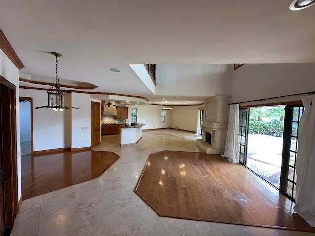 a view of staircase and hall with wooden floor