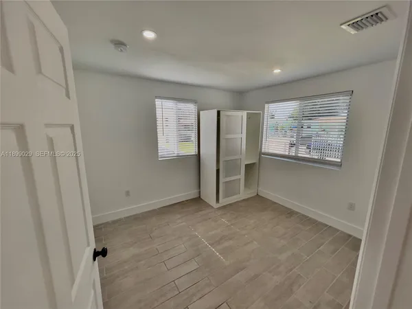 a view of an empty room with a window