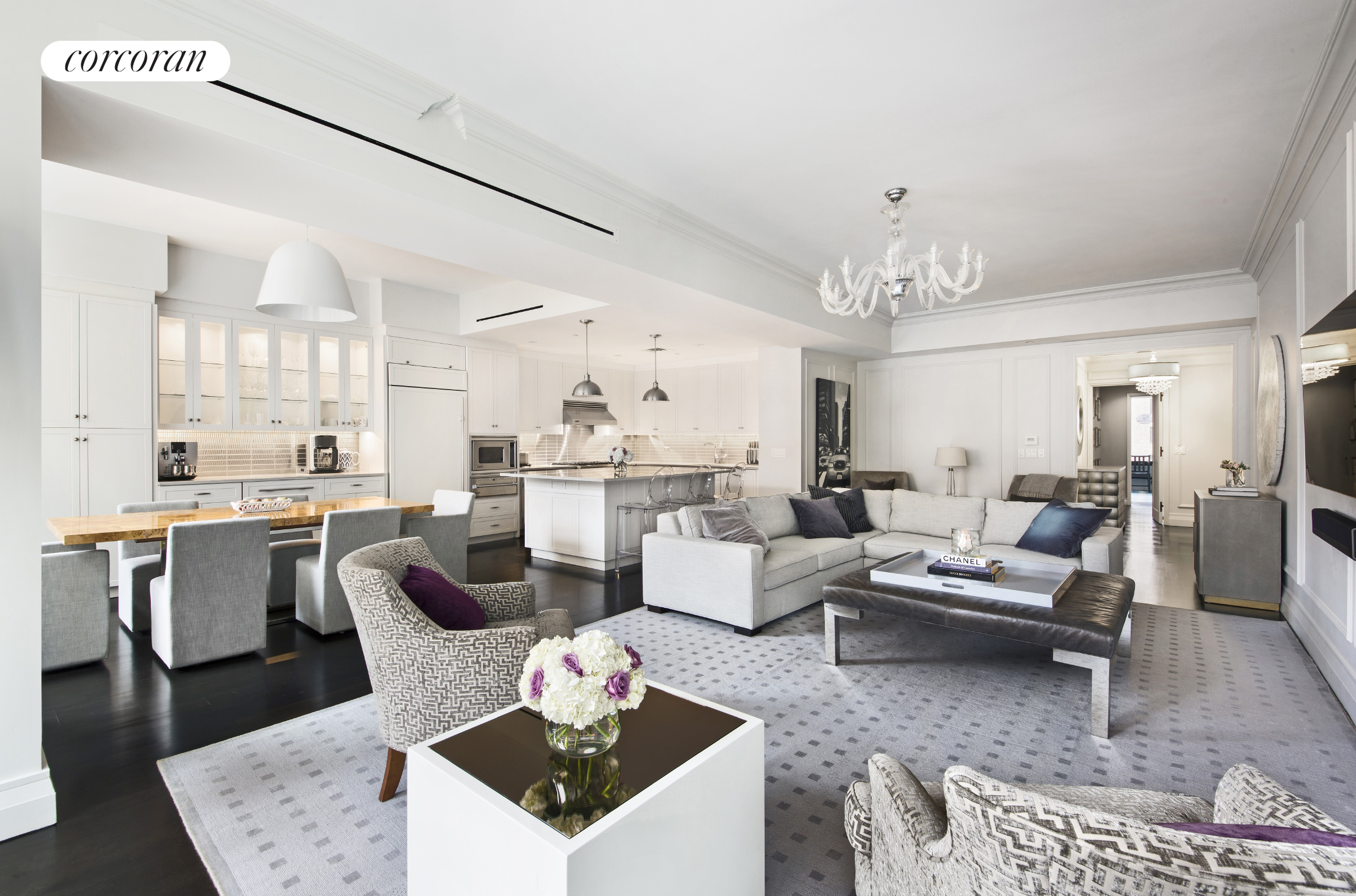 a living room with furniture kitchen view and a chandelier