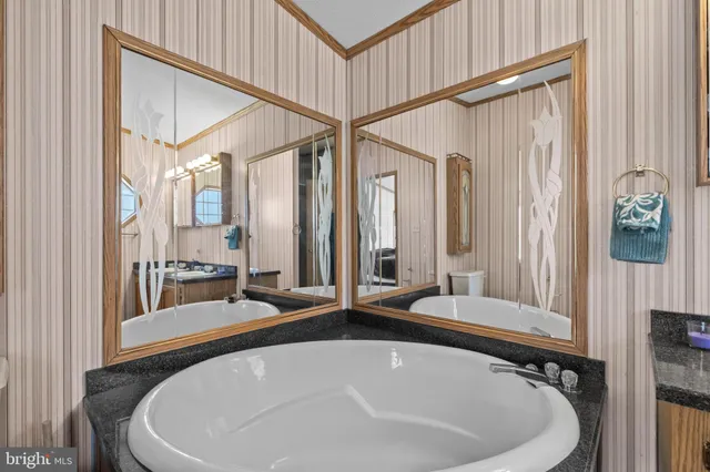 a bath tub sitting next to a bathroom sink