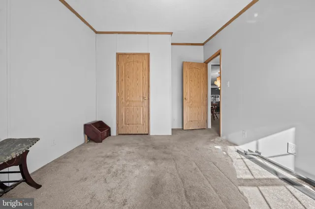 a view of a room with wooden floor and a window