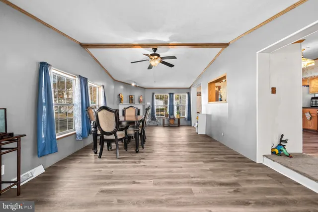 a view of a livingroom with furniture and hardwood floor