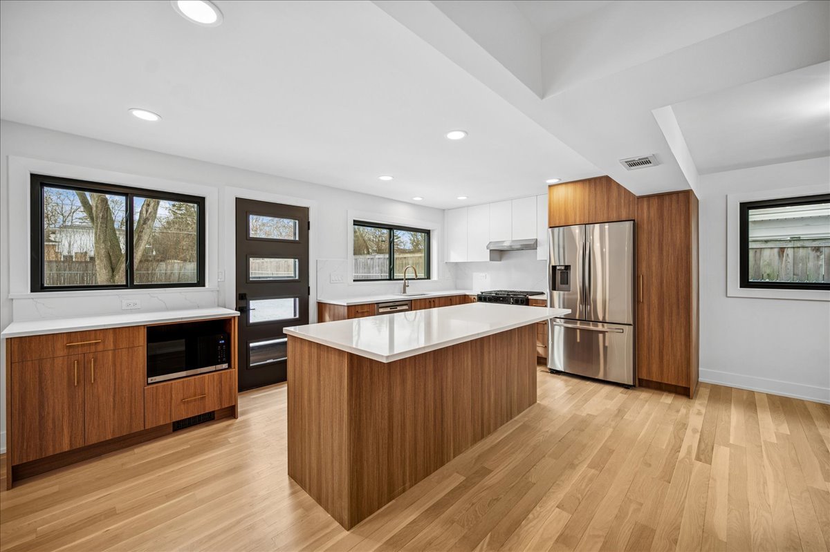 626 Barberry Road Highland Park, IL 60035 - Photo 11 of 38 a kitchen with stainless steel appliances wooden floors and wooden cabinets