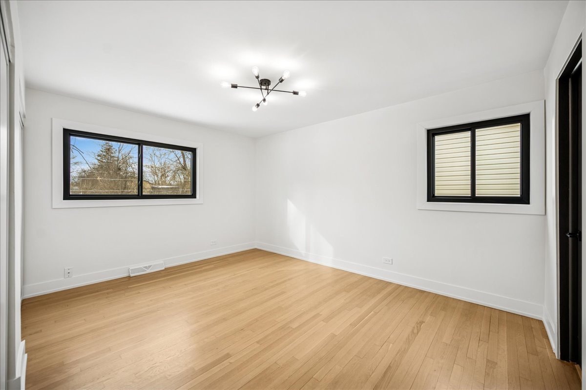 626 Barberry Road Highland Park, IL 60035 - Photo 19 of 38 a view of empty room with wooden floor and fan