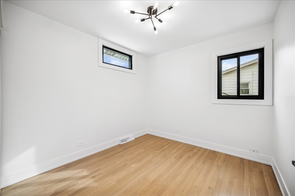 626 Barberry Road Highland Park, IL 60035 - Photo 26 of 38 an empty room with a window and ceiling fan