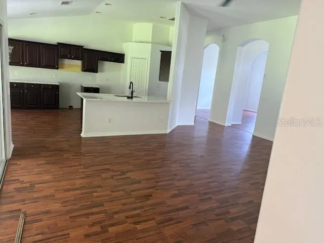 a view of a kitchen with cabinets and wooden floor