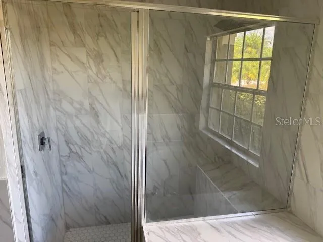a bathroom with a glass shower door