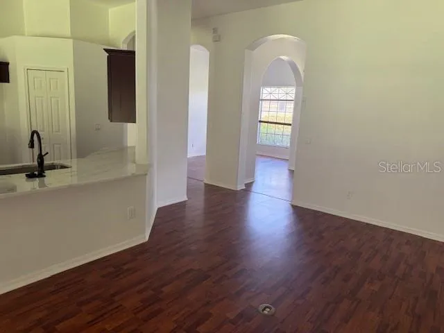 a view of a room with wooden floor and window
