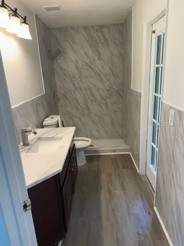 a bathroom with a sink toilet and shower