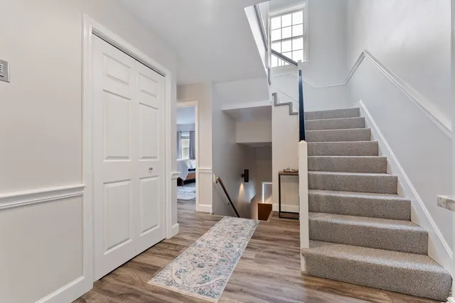 a view of entryway and hall with wooden floor