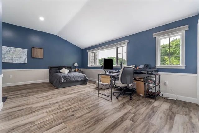 a view of a livingroom with workspace and a window