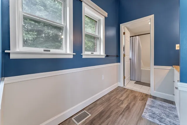 a view of a room with wooden floor and a window