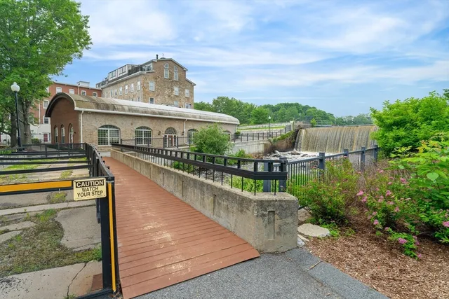 a view of a house with pool and sitting area