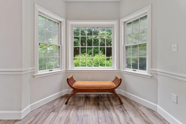 a view of a room with wooden floor and a window