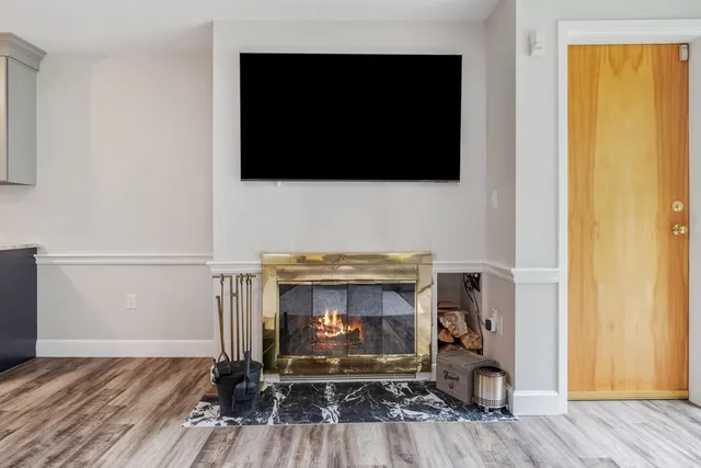a living room with a fireplace and a flat screen tv