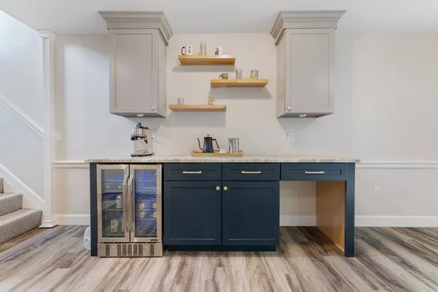 a kitchen with stainless steel appliances granite countertop a sink and cabinets with wooden floor