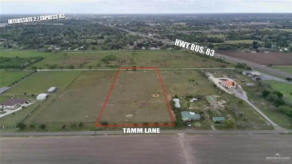 an aerial view of a houses with a yard
