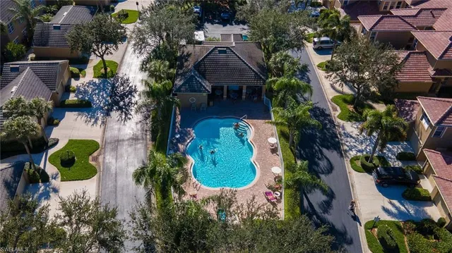 an aerial view of a house with a yard and a large tree