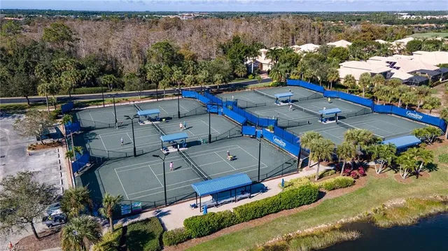 an aerial view of a house with a yard basket ball court and outdoor seating