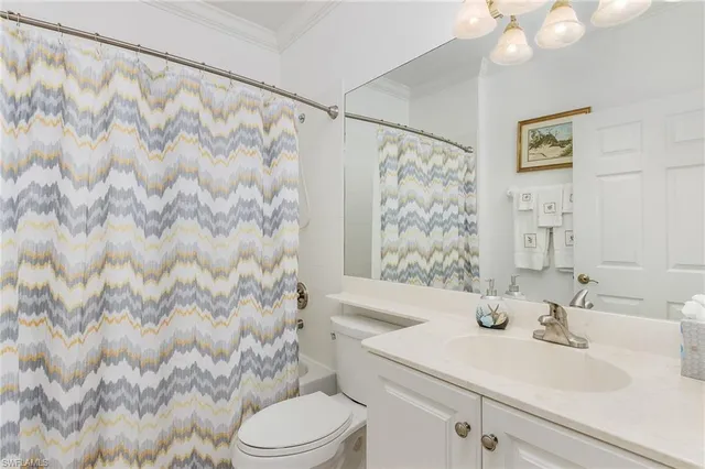 a bathroom with a sink a toilet and shower curtain