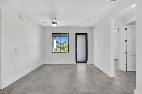 an empty room with windows and closet