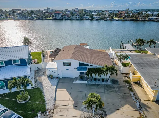 an aerial view of a house with outdoor space and lake view