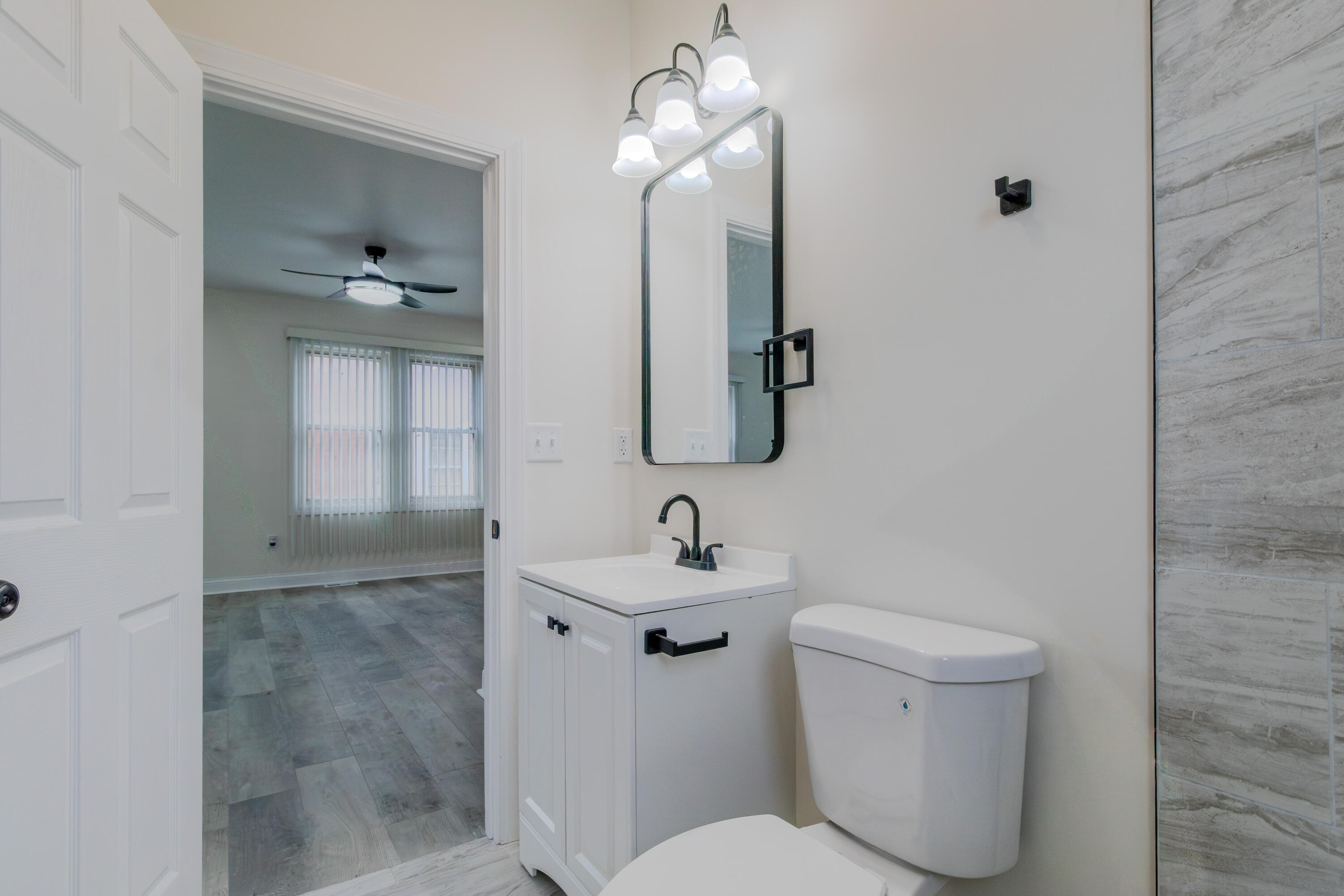 3678 Jackson Street Gary, IN 46408 - Photo 13 of 27 a bathroom with a toilet sink and mirror