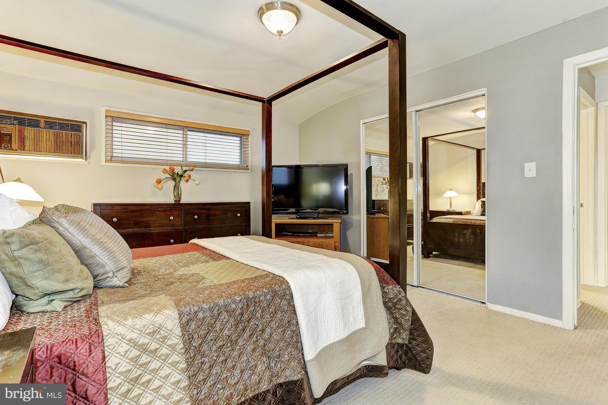3303 Greenmead Road Windsor Mill, MD 21244 - Photo 15 of 20 a bedroom with a large bed and a tv