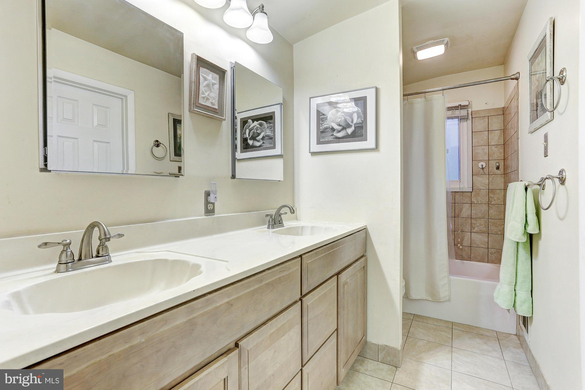 3303 Greenmead Road Windsor Mill, MD 21244 - Photo 16 of 20 a bathroom with a sink and a mirror