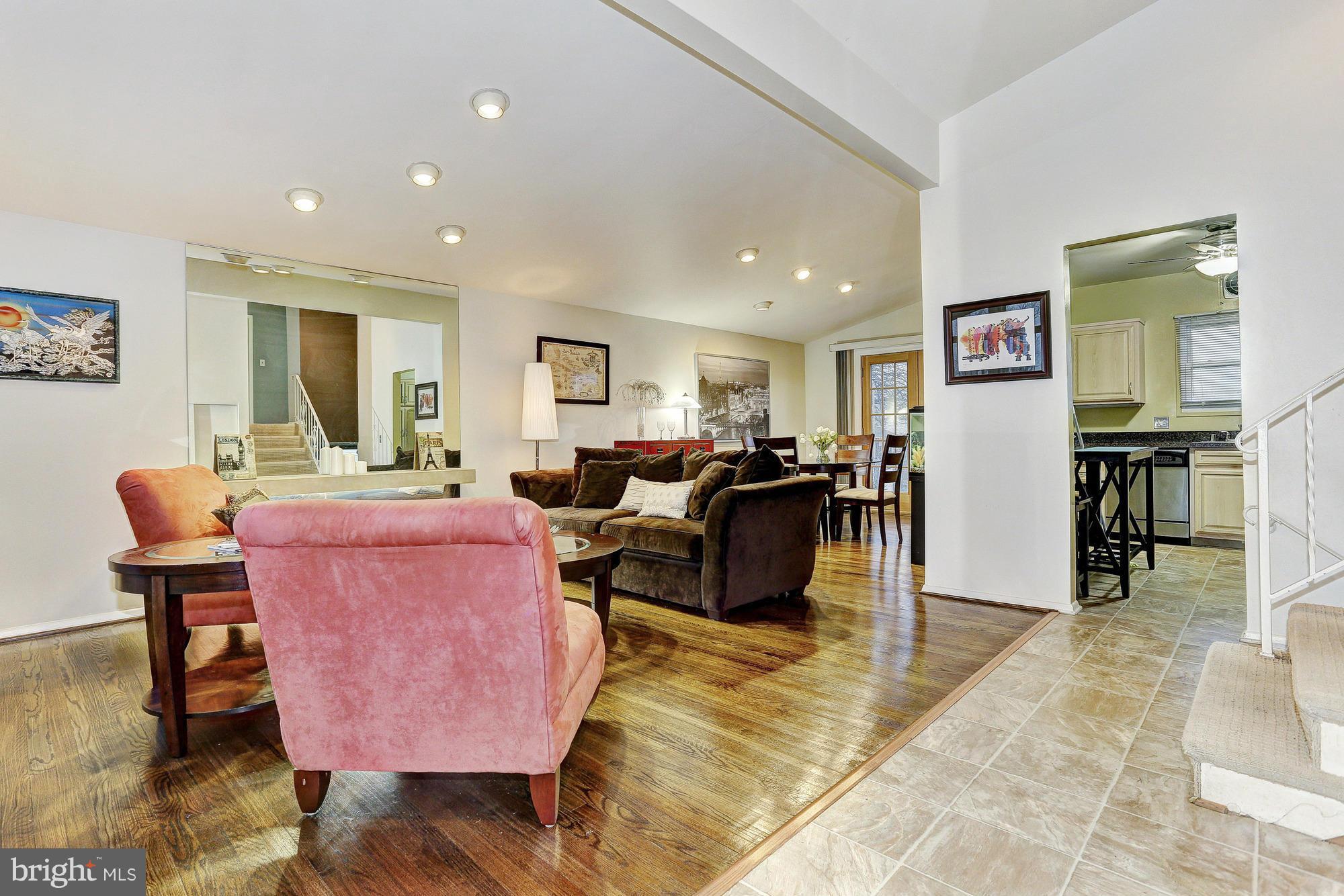 3303 Greenmead Road Windsor Mill, MD 21244 - Photo 4 of 20 a living room with furniture and a dining table with wooden floor