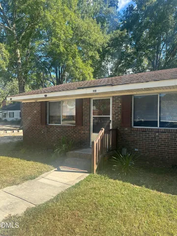 a backyard of a house with yard barbeque oven and outdoor seating