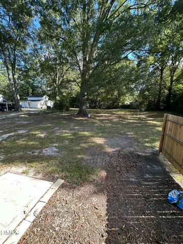 a view of a yard with large trees