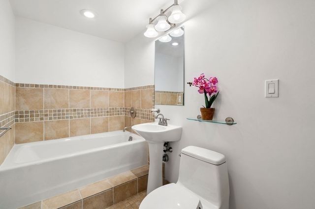 a bathroom with a sink a toilet and bathtub