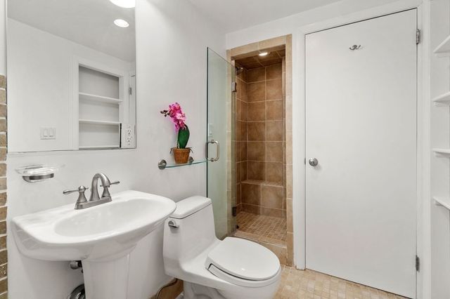a bathroom with a sink toilet and shower